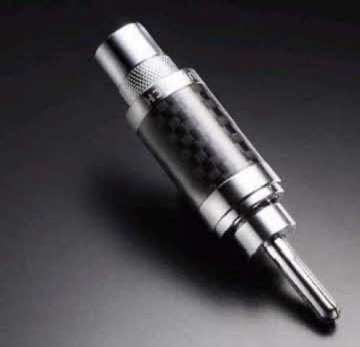 Close-up of a shiny metal audio jack plug on a dark surface.