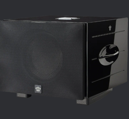Black compact toaster oven with a mesh door and chrome control knob on the right, set against a dark background.