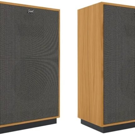 Pair of wooden speakers with black mesh grilles standing on dark bases.