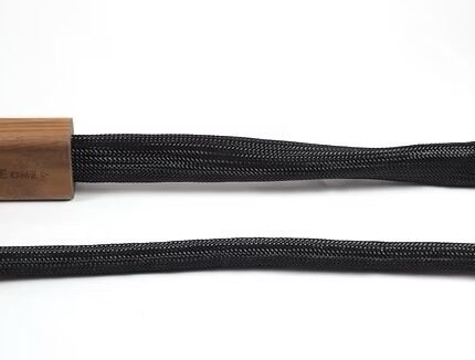 Close-up of two black braided cords with a wooden end cap on the left, laid horizontally on a white background.