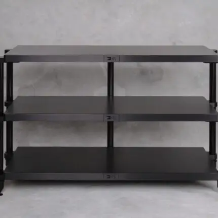 Black three-tier metal shelf unit with vertical posts on a gray concrete background from the front.